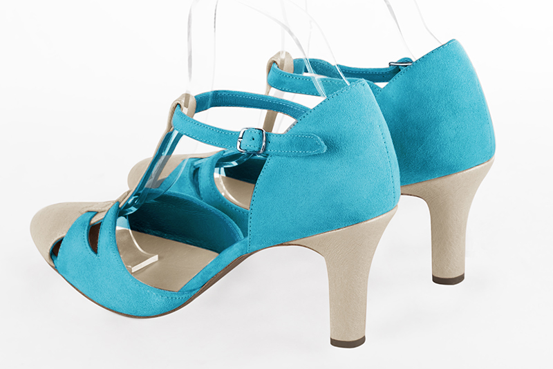 Gold and turquoise blue women's T-strap open side shoes. Round toe. High kitten heels. Rear view - Florence KOOIJMAN